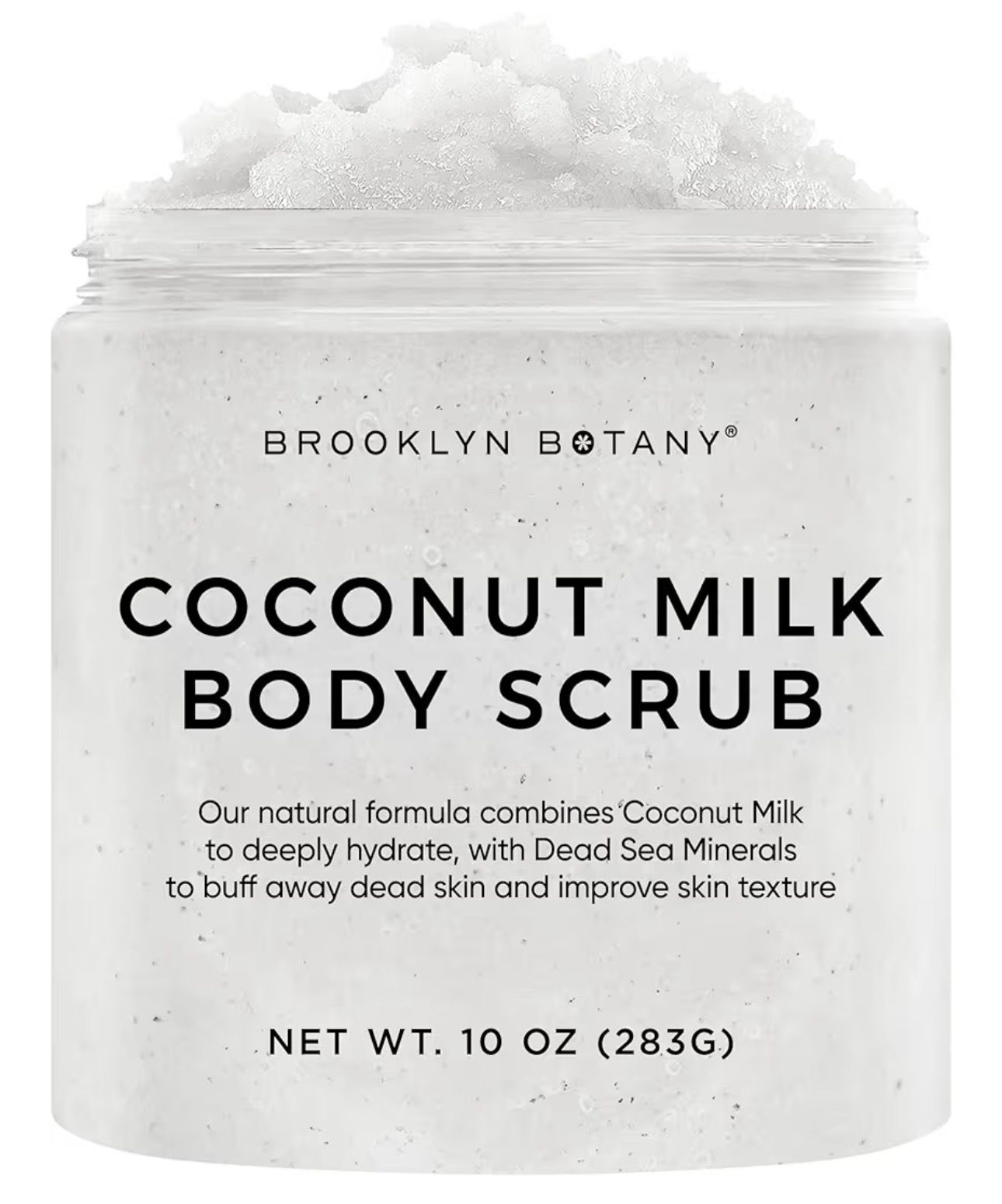 Frasco abierto de exfoliante corporal de coco junto a un coco partido sobre fondo rosa