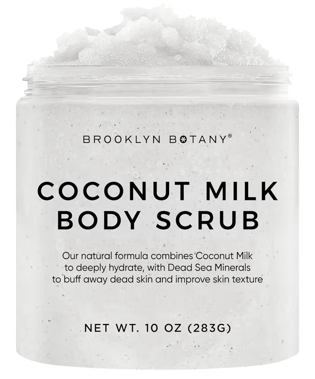 Frasco abierto de exfoliante corporal de coco junto a un coco partido sobre fondo rosa